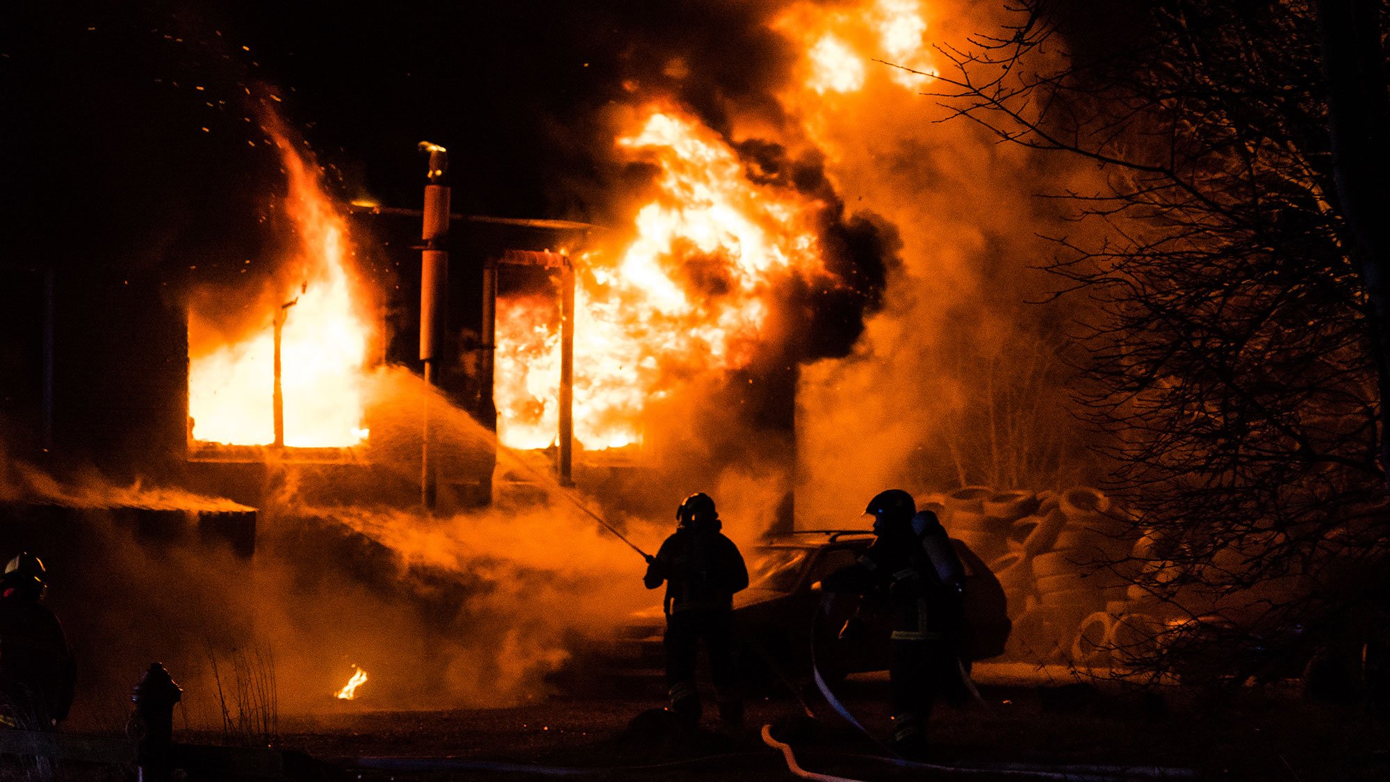 Firefighters tackling a structure fire at night